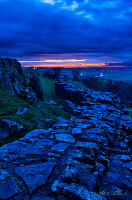 Hadrian's Wall at Walltown Crags in Northumberland at sunset.