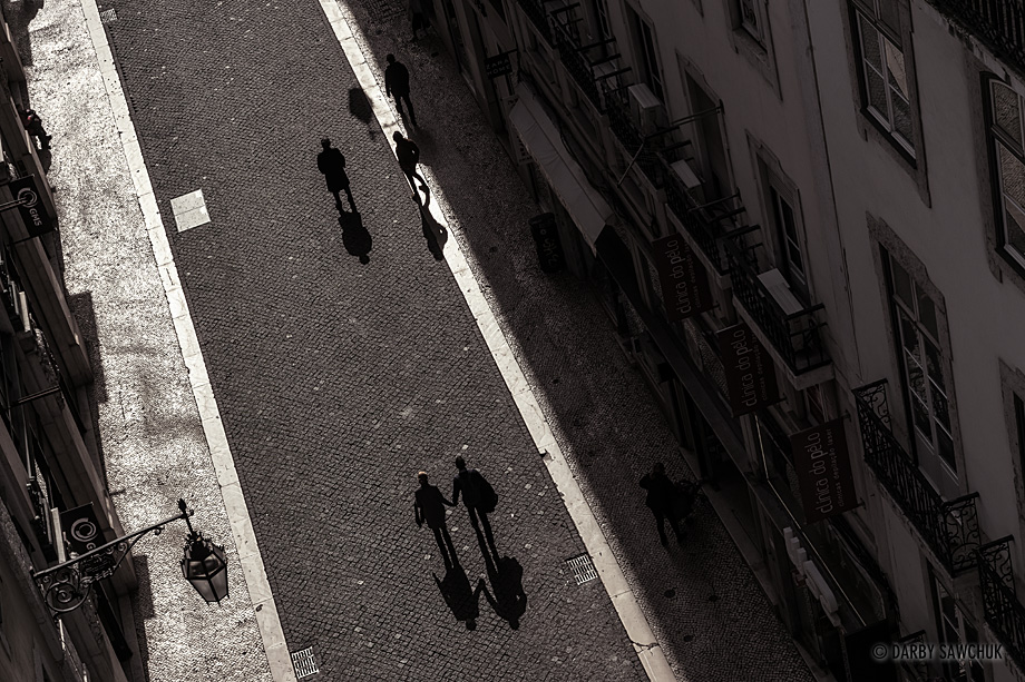 Pedestrians walk along Rua de Carmo in Lisbon, Portugal.