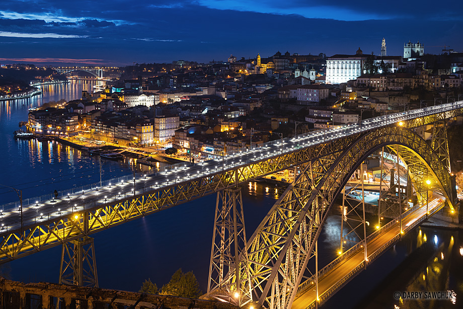 The Dom Luís I Bridge lit up at night crossing the River Douro in Porto, Portugal.