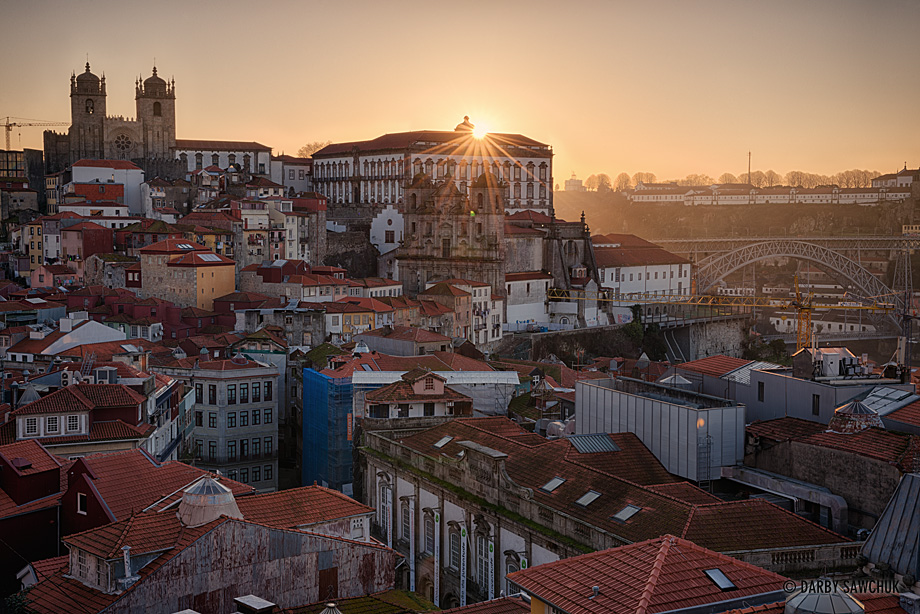 The sun rises over the rooftops of Porto as viewed from the Miradouro da Vitoria.