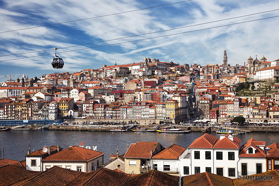 The Gaia Cable Car soars over Vila Nova de Gaia with a grand view of Porto on the other side of the River Douro.