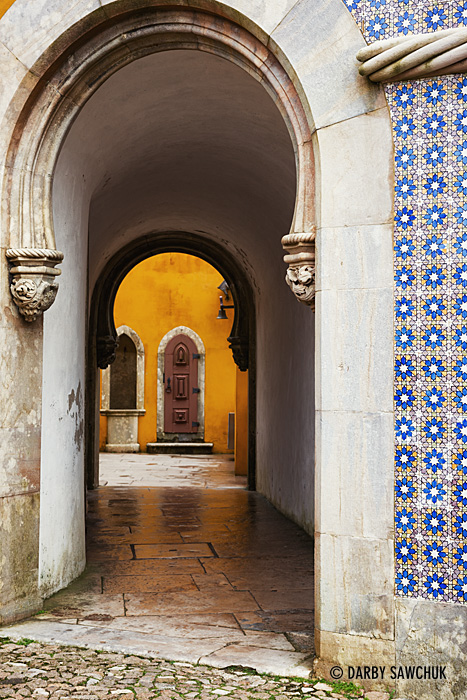 Colourful walls flank archways leading through the courtyard of the National Palace of Pena in Sintra.