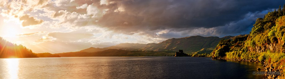 Panoramic view of Eilean Donan Castle at sunset in Scotland.