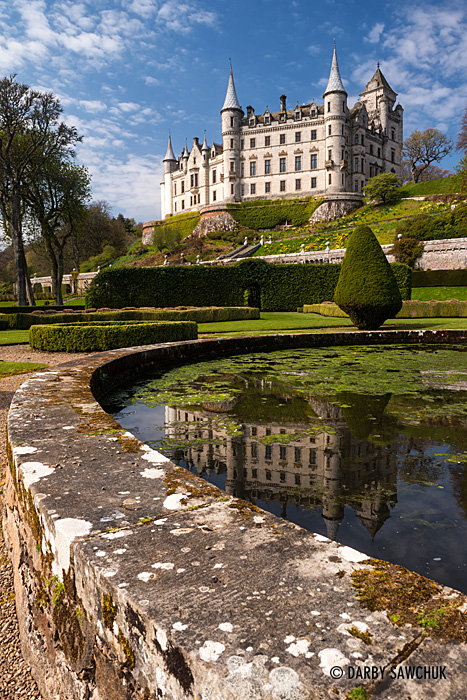 Dunrobin Castle and its reflection in a fountain in Sutherland, Scotland.