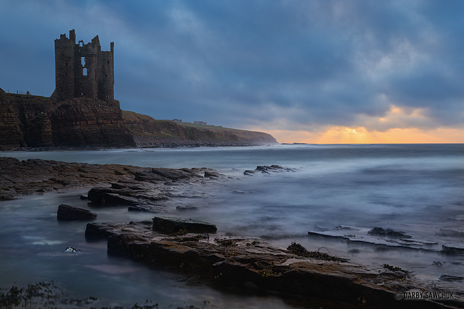 The ruined tower of Old Keiss Castle at sunrise on the coast of Caithness, Scotland.