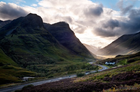 A road weaves through the Eastern end of Glen Coe, Scotland.