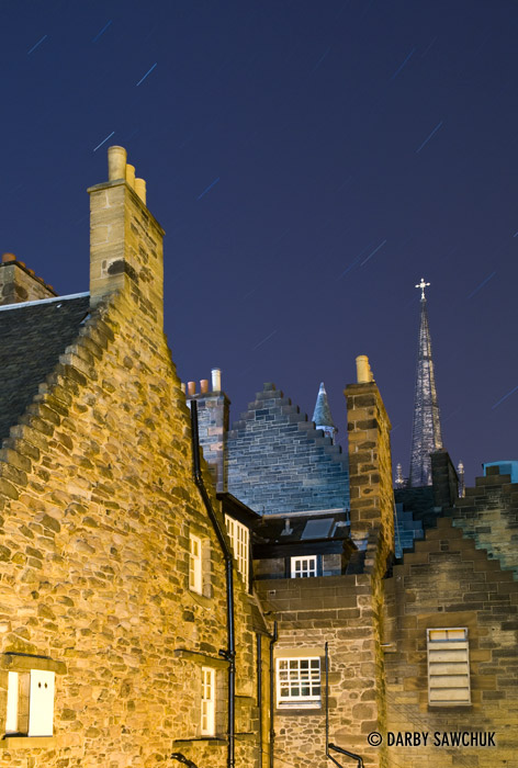 Star trails over brick buildings in Edinburgh, Scotland.