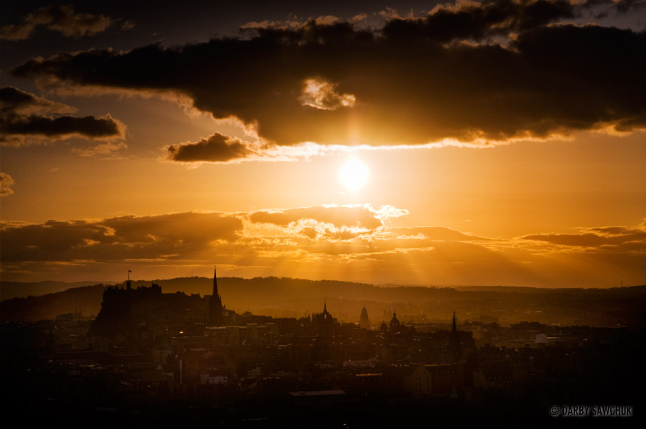 The sun sets over Edinburgh, Scotland.