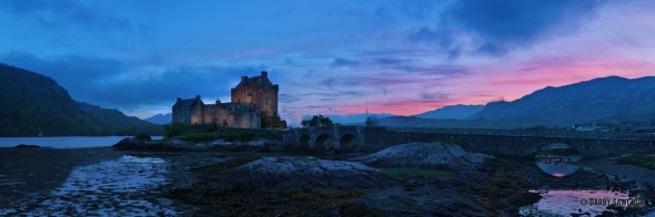 A panoramic image of dusk at Eilean Donan Castle in Scotland.