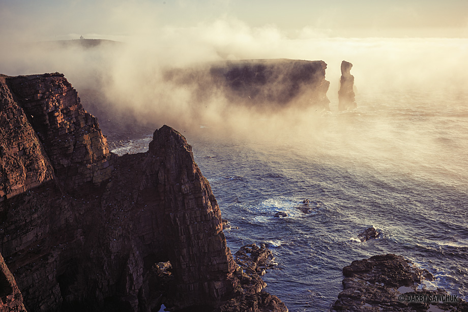 Mist rolls over the Duncansby Stacks in Caithness in the north of Scotland.