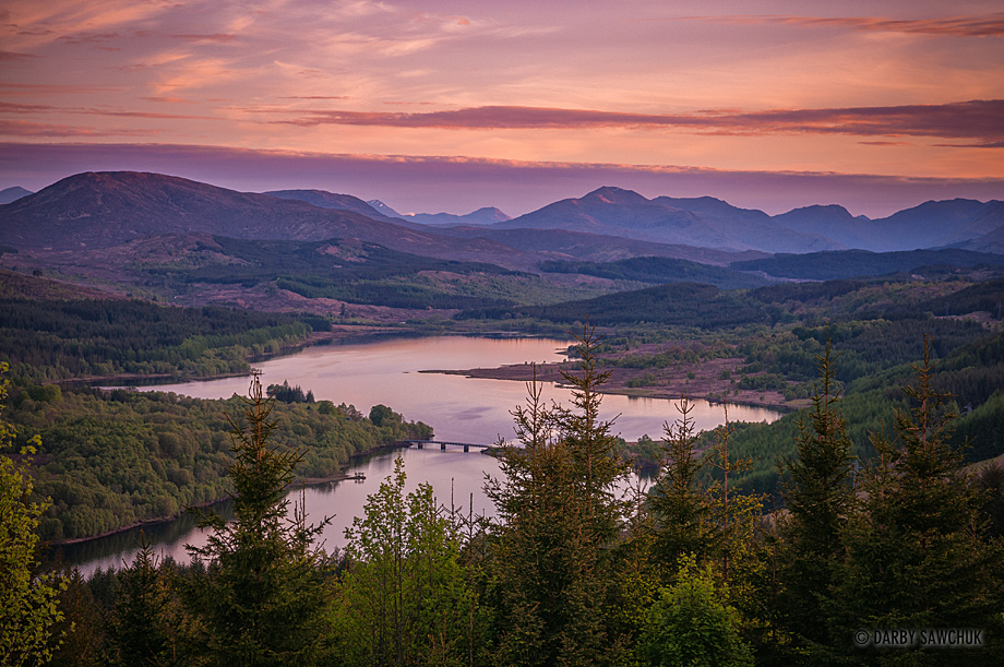 The sun sets over Loch Garry in the Highlands of Scotland.