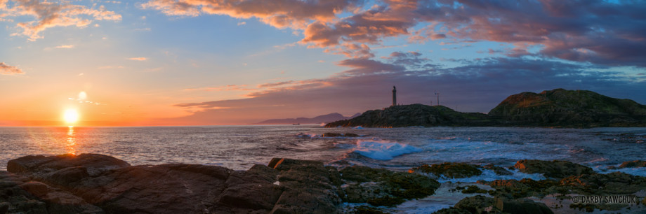 A panoramic view of the lighthouse at Ardnamurchan Point at sunset in western Scotland.