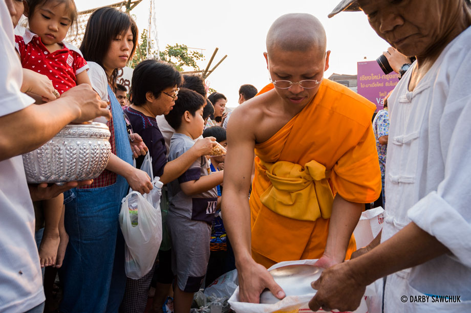 Buddhist monks participate in morning merit-making ceremonies during Songkran, the Thai New Year, in Chiang Mai Thailand.