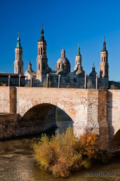 The Basilica of Our Lady of the Pillar and the Puente de Piedra spanning the Ebro River in Zaragoza, Spain.