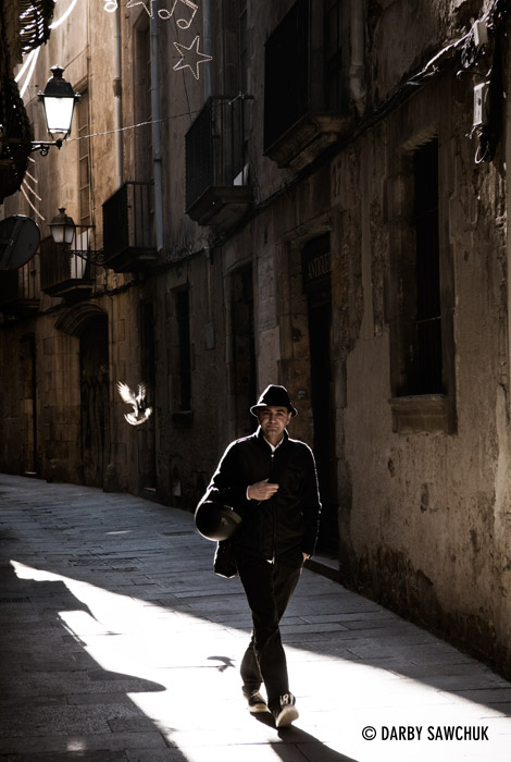A man walks through the gothic quarter in Barcelona, Spain.