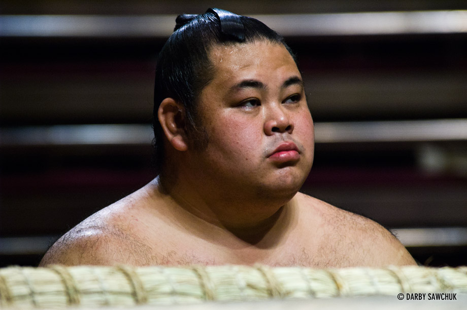 A sumo wrestler at ringside at the Ryogoku stadium in Tokyo, Japan.