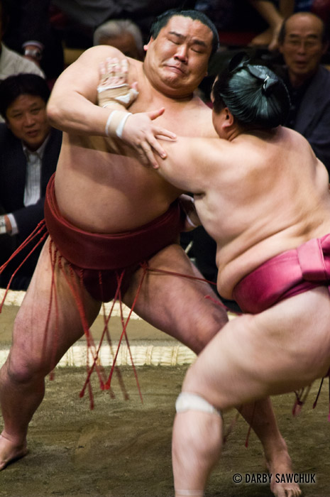 Sumo wrestlers grapple at the Ryogoku stadium in Tokyo, Japan.