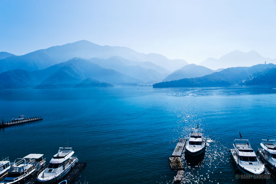 Boats docked in the blue waters of Sun Moon Lake, the largest lake in Taiwan.