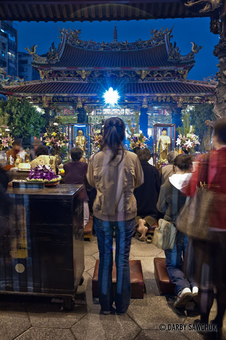 Worshippers pray at Mengjia Longshan Temple in Taipei, Taiwan. The temple worships a mix of Buddhist, Taoist and folk deities.