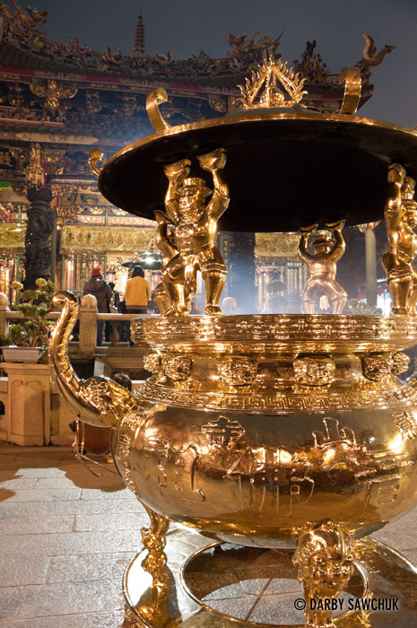 A golden urn where incense is burned in the inner courtyard of Longshan temple in Taipei, Taiwan.