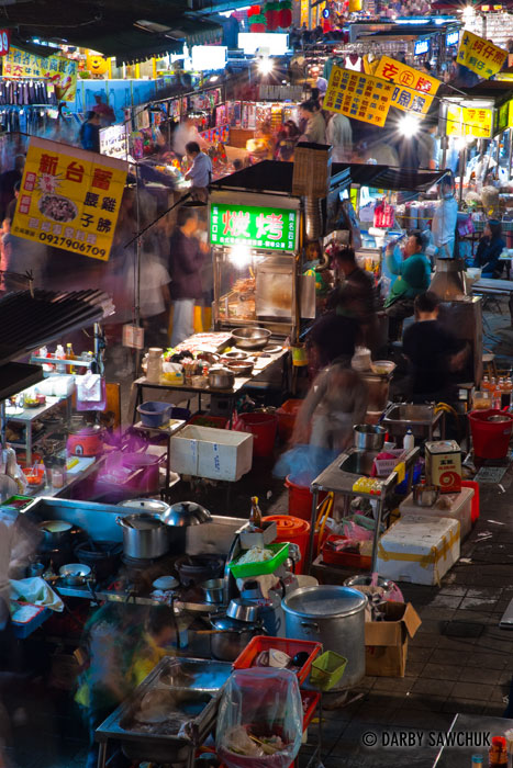Food vendors prepare meals for patrons of the Snake Alley Night Market in Taipei, Taiwan.