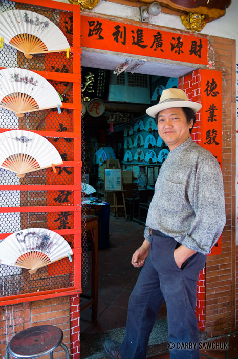 A merchant selling decorated Chinese paper fans on Old Market Street in Lukang, Taiwan.