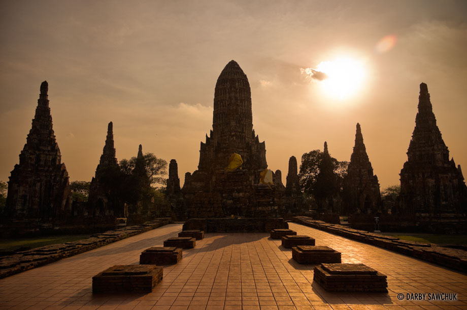 The sun sets on Wat Chaiwatthanaram, an ancient Buddhist temple in Ayutthaya, Thailand.