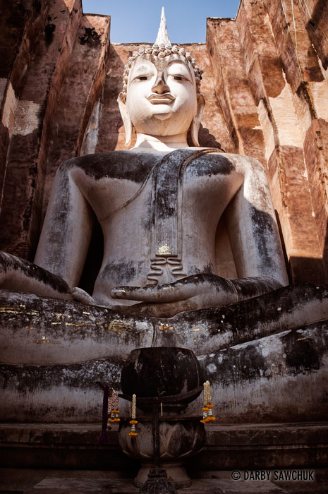A giant Buddha statue, Phra Achana at Wat Si Chum in the Sukhothai Historic Park in Thailand.