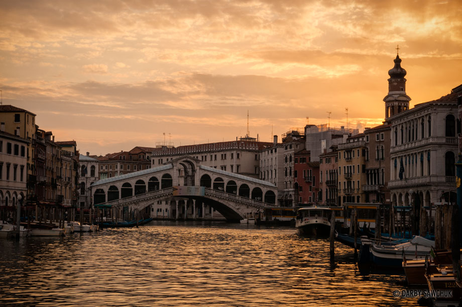 The Rialto Bridge and the Grand Canal at sunrise in Venice, Italy.