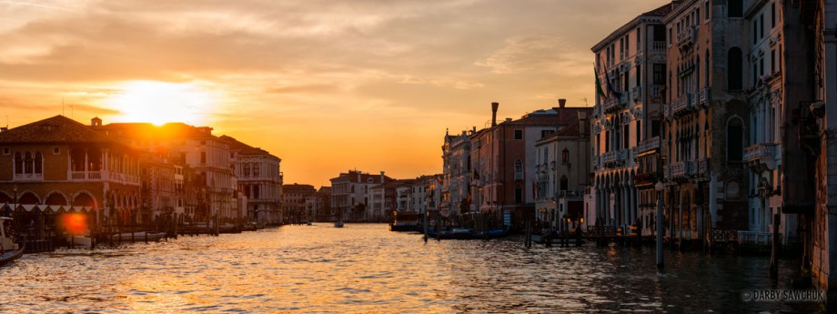 The sun sets in a panoramic view of the Grand Canal in Venice, Italy.