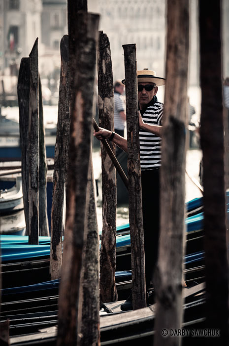 A gondolier waits on his boat for new passengers in Venice.