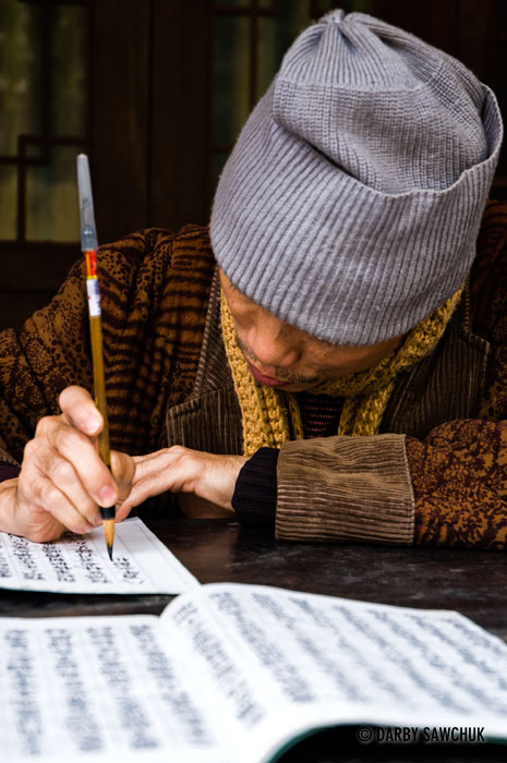 A calligrapher writes script at a temple in Hanoi.