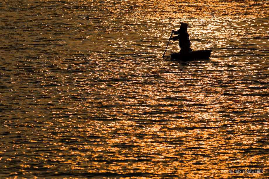 A boatsman at sunset on the Thu Bon River in Hoi An Vietnam.