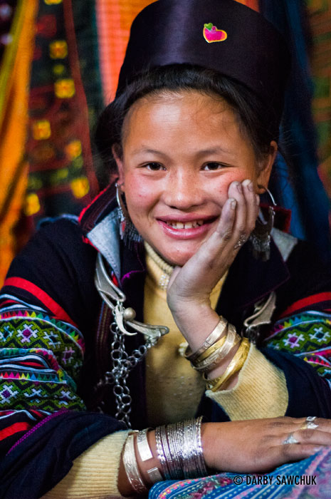 A Black Hmong girl waits with her crafts in the market of Sa Pa, Vietnam.