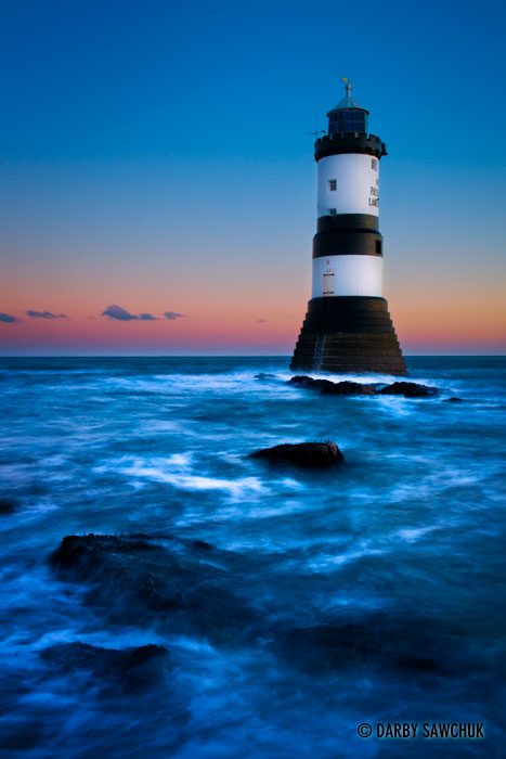 The lighthouse off Penmon Point on the island of Anglesey at dawn in Wales.