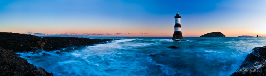 A panoramic view of the lighthouse off Penmon Point on the island of Anglesey at dawn in Wales.