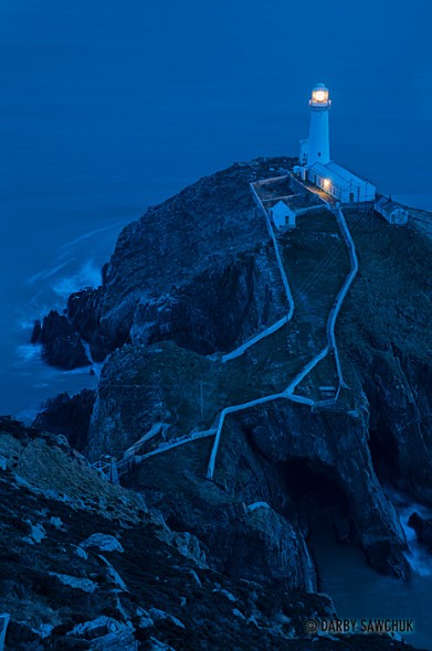 The South Stack Lighthouse at dusk on the island of Anglesey in North Wales, UK.