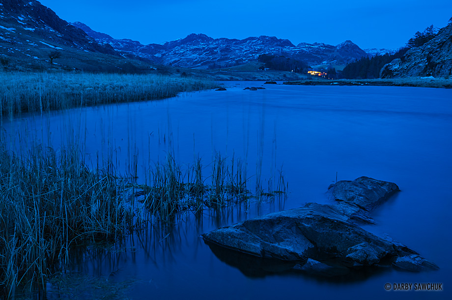 Looking towards Capel Curig and the mountains of Snowdonia at dusk from the shores of Llynnau Mymbyr lake in North Wales.