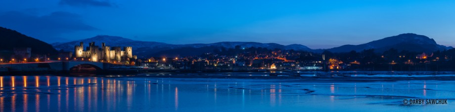 A panoramic view of Conwy and Conwy Castle at dusk viewed from across River Conwy